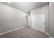 Neutral bedroom with sliding closet doors, trim, and hallway entrance at 8894 Yellowcress St, Littleton, CO 80125