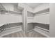 Walk-in closet features carpeted floors, and built-in shelving and hanging rods for optimal organization at 8894 Yellowcress St, Littleton, CO 80125