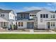 Beautiful two-story home with blue accents, stone trim, and manicured landscaping at 8894 Yellowcress St, Littleton, CO 80125