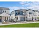 New construction townhomes feature modern architecture, colorful siding, and inviting front porches at 8894 Yellowcress St, Littleton, CO 80125