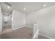 Bright hallway space with neutral walls and carpet, leading to multiple rooms at 8894 Yellowcress St, Littleton, CO 80125