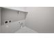 Laundry room with tile floor, shelf, and hookups at 8894 Yellowcress St, Littleton, CO 80125
