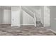 Open living space featuring wood flooring, a staircase and a white interior door at 8894 Yellowcress St, Littleton, CO 80125