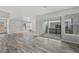 Open living space with wood floors, large windows, and sliding glass doors at 8894 Yellowcress St, Littleton, CO 80125
