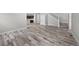 Open living space with wood flooring, staircase, and view to the kitchen at 8894 Yellowcress St, Littleton, CO 80125