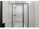 The shower features white marble-look tiles and black fixtures, complete with a comfortable built-in bench at 8894 Yellowcress St, Littleton, CO 80125