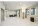 Finished basement area with large windows, bright lighting, and an open layout at 13901 E Saratoga Pl, Aurora, CO 80015