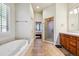 Luxurious bathroom featuring a soaking tub, walk-in shower, and double sink vanity at 13901 E Saratoga Pl, Aurora, CO 80015