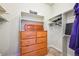 Walk-in closet with built-in storage, shelving, and closet rod organization at 13901 E Saratoga Pl, Aurora, CO 80015