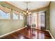 Formal dining room with rich hardwood floors, elegant chandelier, and ample natural light at 13901 E Saratoga Pl, Aurora, CO 80015