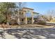 Two-story home boasts balconies, stucco exterior, manicured lawn, and mature trees in a quiet neighborhood at 13901 E Saratoga Pl, Aurora, CO 80015