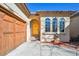 Inviting home exterior with a striking wooden garage door and bright yellow arched front door at 13901 E Saratoga Pl, Aurora, CO 80015