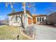 Charming single-story home showcasing a well-manicured yard, attached garage, and inviting yellow front door at 13901 E Saratoga Pl, Aurora, CO 80015