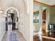 Elegant hallway featuring arched ceilings, and tiled floors, with views of the living spaces and a side nook at 13901 E Saratoga Pl, Aurora, CO 80015