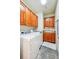 Well-equipped laundry room features a washer and dryer, built-in cabinets, and tile floor at 13901 E Saratoga Pl, Aurora, CO 80015