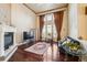Spacious living room with high ceilings, fireplace, large windows, and comfortable seating at 13901 E Saratoga Pl, Aurora, CO 80015