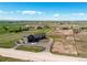 Expansive aerial view of a gray two-story home, pastures, outbuildings, and surrounding countryside at 42919 Vista Rdg, Parker, CO 80138