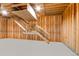 Unfinished basement with exposed wooden beams, stairs, and a gray concrete floor provides potential for customization at 42919 Vista Rdg, Parker, CO 80138