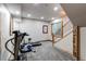 Finished basement exercise area features gym equipment and staircase at 42919 Vista Rdg, Parker, CO 80138