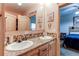 Charming bathroom with double sinks, decorative mirrors, and rustic accents; a cozy retreat within the home at 42919 Vista Rdg, Parker, CO 80138