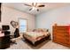 Comfortable bedroom with a computer desk, bed, and a window letting in natural light at 42919 Vista Rdg, Parker, CO 80138