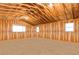 Unfinished bonus room with exposed beams, three windows, and a wood floor is ready for customization at 42919 Vista Rdg, Parker, CO 80138
