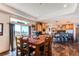 The dining room is bright, with patio access and wooden furniture at 42919 Vista Rdg, Parker, CO 80138