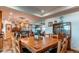 Open concept dining room and kitchen area with a large wooden dining table and seating for eight at 42919 Vista Rdg, Parker, CO 80138