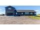 Charming two-story home with a dark gray exterior, a spacious front yard, and an attached garage at 42919 Vista Rdg, Parker, CO 80138