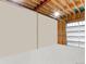 Unfinished garage with exposed beams, a white door, and a gray concrete floor offers plenty of space at 42919 Vista Rdg, Parker, CO 80138