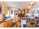 Well-lit kitchen featuring wooden cabinets, granite countertops, and modern appliances at 42919 Vista Rdg, Parker, CO 80138