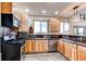 Bright kitchen featuring wood cabinets, stainless steel appliances, and a rustic backsplash at 42919 Vista Rdg, Parker, CO 80138