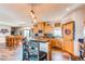 Bright kitchen features custom wood cabinets, stylish lighting, pantry, and island with barstool seating at 42919 Vista Rdg, Parker, CO 80138