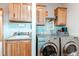 Functional laundry room with washer, dryer, sink, and ample storage space; perfect for efficient home chores at 42919 Vista Rdg, Parker, CO 80138