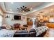 Inviting living room with open floor plan, ceiling fan, and natural light at 42919 Vista Rdg, Parker, CO 80138
