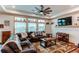 Cozy living room featuring a comfortable sofa, large windows, and a ceiling fan at 42919 Vista Rdg, Parker, CO 80138