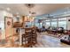 Open-concept living room with hardwood floors, connecting to the dining area and kitchen at 42919 Vista Rdg, Parker, CO 80138