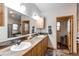 Beautiful main bathroom with double vanity, wood accents, and an abundance of counter space at 42919 Vista Rdg, Parker, CO 80138