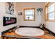 The main bathroom is bright, with a soaking tub and electric fireplace at 42919 Vista Rdg, Parker, CO 80138