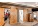 View of the main bedroom with a view of the barn door style entrances to the closet and bathroom at 42919 Vista Rdg, Parker, CO 80138