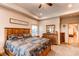 The main bedroom features tray ceilings, natural lighting, and a wooden dresser at 42919 Vista Rdg, Parker, CO 80138