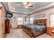 Bright main bedroom with a large bed, two windows, tray ceilings and decor at 42919 Vista Rdg, Parker, CO 80138