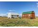 Two outbuildings on a grassy lot, offering storage, workspace, or potential for hobby farming at 42919 Vista Rdg, Parker, CO 80138