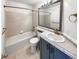 Cozy bathroom with a tub and vanity with gold hardware and decorative mirror at 1491 Ophir Rd, Castle Rock, CO 80109