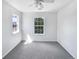 Bright bedroom featuring neutral carpeting, a ceiling fan, and well-lit windows at 1491 Ophir Rd, Castle Rock, CO 80109