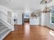 Spacious dining area showcasing hardwood floors, chandelier lighting, and seamless transition to the kitchen at 1491 Ophir Rd, Castle Rock, CO 80109