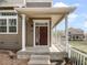 Close-up of the front porch with white columns and a dark brown front door at 1491 Ophir Rd, Castle Rock, CO 80109