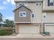 Attached garage with stone accents and tan siding in residential neighborhood at 1491 Ophir Rd, Castle Rock, CO 80109