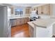 Bright kitchen with stainless steel appliances, light wood cabinets and hardwood floors at 1491 Ophir Rd, Castle Rock, CO 80109