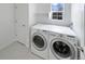 Clean and bright laundry room featuring modern washer and dryer units and a view from the window at 1491 Ophir Rd, Castle Rock, CO 80109